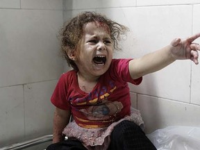 A Palestinian child shouts at al-Shifa hospital after Israeli forces shelled her house in Gaza City on July 18, 2014. Israel began a ground operation in Gaza as a deadly offensive to stamp out rocket fire from the Hamas-run enclave that has cost 247 Palestinian lives entered its 11th day on July 18.