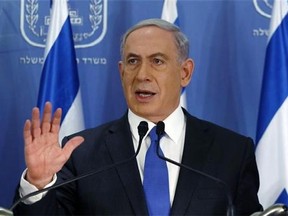 Israeli Prime Minister Benjamin Netanyahu gestures as he speaks during a press conference at the defense ministry in the Israeli coastal city of Tel Aviv on Friday, July 11, 2014. The Israeli Defense Forces have begun a ground operation in the Gaza Strip.