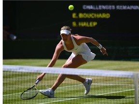 Canada's Eugenie Bouchard serves the ball to to Romania's Simona Halep during their women's singles semi-final match on day ten of the 2014 Wimbledon Championships at The All England Tennis Club in Wimbledon, southwest London, on July 3, 2014. (GLYN KIRK/AFP/Getty Images)