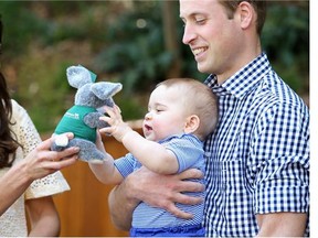 Prince William holds  Prince George as Kate gives her son  a toy bilby in Australia last April.