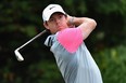 McIlroy swooshes past Tiger wit…