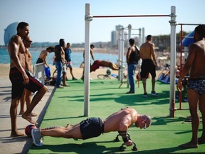 People work out on the beach, in Barcelona, Spain, Thursday, July 17, 2014. Most of Spain is currently suffering from a heat wave with temperatures reaching around 40 degrees Celsius.