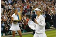 Petra Kvitova of the Czech Republic, left, holds her trophy after defeating  Montrealer Eugenie Bouchard, at right, in the women’s singles final match at Wimbledon on Saturday.