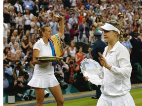 Petra Kvitova of the Czech Republic, left, holds her trophy after defeating  Montrealer Eugenie Bouchard, at right, in the women’s singles final match at Wimbledon on Saturday.