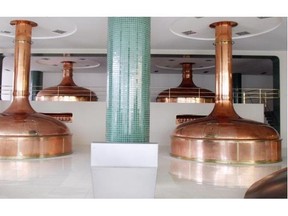 Pilsner Urquell’s brewhouse, where some of its 16 copper kettles perform the mashing and filtering process.