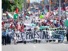 Protestors march along Elgin Street in Ottawa during the “Rally Against Israeli Brutality” protest in response to the crisis in Gaza, on Saturday, July 12, 2014.