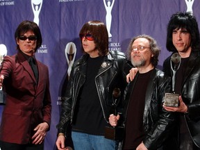 In this March 18, 2002, file photo, members of the Ramones, from left to right, Dee Dee, Johnny, Tommy and Marky Ramone hold their awards after being inducted at the Rock and Roll Hall of Fame induction ceremony at New York's Waldorf Astoria. (AP Photo/Ed Betz, File)