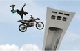 Rider Shawn Connors in flight on the esplanade of the Olympic Stadium during a motocross jump demonstration as part of the Jackalope action sports festival in Montreal, on Saturday, July 19, 2014. The festival took place over the weekend.