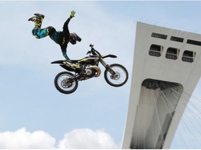 Rider Shawn Connors in flight on the esplanade of the Olympic Stadium during a motocross jump demonstration as part of the Jackalope action sports festival in Montreal, on Saturday, July 19, 2014. The festival took place over the weekend.