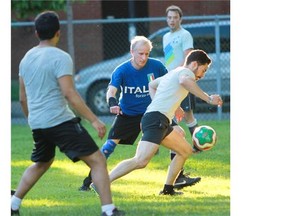 Ross Stevenson (in Italia T-shirt) watches as Renaud Madeline tries to control a ball during a recent soccer game in a Montreal park. Stevenson is part of a group that has been playing in Montreal parks informally for the past 25 years.