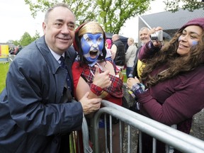 Scotland’s First Minister and Scottish National Party (SNP) leader Alex Salmond (L) poses June 28 for a photograph at the re-enactment to commemorate the 700th anniversary of the Battle Of Bannockburn in 1314. The anniversary falls three months before Scotland holds a referendum in September on whether to stay or leave the United Kingdom.