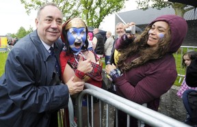 Scotland’s First Minister and Scottish National Party (SNP) leader Alex Salmond (L) poses June 28 for a photograph at the re-enactment to commemorate the 700th anniversary of the Battle Of Bannockburn in 1314. The anniversary falls three months before Scotland holds a referendum in September on whether to stay or leave the United Kingdom.