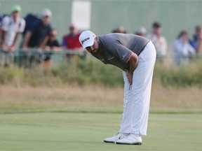 Shane Lowry of Ireland lines up a putt on the 18th green during the first day of the British Open Golf championship at the Royal Liverpool golf club, Hoylake, England, Thursday July 17, 2014.
