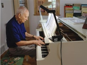 Ian Smith, a longtime West Island resident, musician and teacher plays piano at his home in the Roxboro area of Montreal on Sunday, July 20, 2014 as his wife, Mary, turns pages of the score. His book, The Essence of Victorian Opera, based on his doctoral thesis, was published this year. The scholarly book was accepted for publication more than 25 years ago but not until Mary found the acceptance letter from the publisher in 2011, while cleaning out the attic for a renovation, did Smith act on it: He wrote to the publishers to ask if they were still interested: They were.