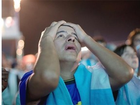 A soccer fan of the Argentina national soccer team holds his head with his hands during a live broadcast of the soccer World Cup final match between Argentina and Germany, inside the FIFA Fan Fest area on Copacabana beach, in Rio de Janeiro, Brazil, on Sunday. Mario Goetze scored the winning goal in extra time to give Germany its fourth World Cup title with a 1-0 victory over Argentina.