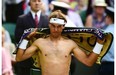 Spain’s Rafael Nadal changes his shirt between sets during his men’s singles fourth round match against Australia’s Nick Kyrgios at the 2014 Wimbledon Championships.