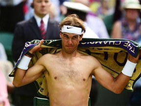 Spain’s Rafael Nadal changes his shirt between sets during his men’s singles fourth round match against Australia’s Nick Kyrgios at the 2014 Wimbledon Championships.