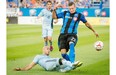 Sporting Kansas City’s Aurelien Collin slides in as he tries to block the pass to Montreal Impact’s Krzysztof Krol during first half MLS action in Montreal on Saturday.