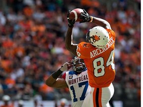 B.C. Lions' Emmanuel Arceneaux, right, makes a touchdown reception as Montreal Alouettes' Billy Parker defends during the first half of a CFL football game in Vancouver, B.C., on Saturday July 19, 2014.