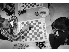 Sarah Reid from Ste Marguerite D'Youville plays a game of chess against Ilija Pavicic from St. William during the 2013 Windsor Chess Challenge.