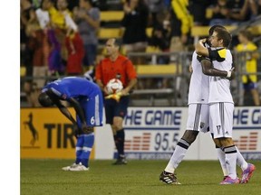 Columbus Crew players celebrates while a Montreal Impact player shows dejection at the end of a soccer match at Crew Stadium, Saturday, July 19, 2014, in Columbus, Ohio.