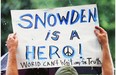 A supporter holds a sign at a small rally on behalf of National Security Administration (NSA) whistleblower Edward Snowden in New York City in June 2013. Alberta’s Whistleblower Protection Act is flawed legislation that doesn’t truly protect civil servants, the Journal writes in an editorial.