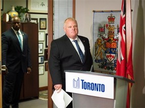 Toronto Mayor Rob Ford arrives for an invite-only press conference at City Hall in Toronto on Monday, June 30, 2014.
