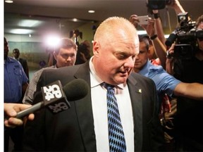 Toronto Mayor Rob Ford leaves his office at city hall in Toronto on Monday June 30, 2014, after his first day back at work following his stay in a rehabilitation clinic.