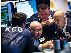 Traders work on the floor of the New York Stock Exchange during the morning of July 3, 2014, in New York City. The Dow Jones passed 17,000 for the first time today, as economy continues to recover.