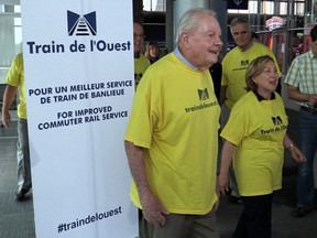 A delegation of about 15 people, including Train de l’Ouest spokesman Clifford Lincoln and Baie-d'Urfé Mayor Maria Tutino wear bright yellow T-shirts as they head to meet the Transport minister. (Gazette file photo)