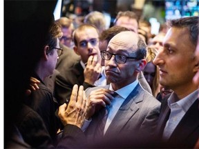 Twitter CEO Dick Costolo adjusts his tie while waiting to see what Twitter’s opening market price will be on the floor of the New York Stock Exchange (NYSE) on November 7, 2013. Twitter stock surged July 30 as Costolo announced the company’s revenue more than doubled to US$312.2 million in its second quarter.