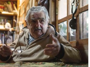 Uruguayan President Jose Mujica gestures during an interview with Agence France-Presse at his house, on the outskirts of Montevideo on July 9, 2014. Mujica told AFP Wednesday that sales of marijuana will be delayed until next year because of difficulties in implementing the controversial law legalizing the drug. The South American country in December became the first in the world to announce that it would regulate the market for cannabis and its derivatives.