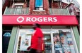 A man walks by a Rogers store in Toronto, Wednesday, August 15, 2013. Canadian telecom stocks are down as the government seeks a fourth wireless provider for the country.