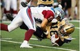 Winnipeg Blue Bombers quarterback Robert Marve is tackled by Alouettes linebacker Chip Cox during second quarter CFL football action Friday, July 11, 2014 in Montreal.