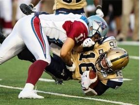 Winnipeg Blue Bombers quarterback Robert Marve is tackled by Alouettes linebacker Chip Cox during second quarter CFL football action Friday, July 11, 2014 in Montreal.