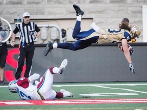 Winnipeg Blue Bombers wide receiver Julian Feoli-Gudino flies over Montreal Alouettes defensive back Jamaan Webb during first quarter CFL football action Friday, July 11, 2014 in Montreal.