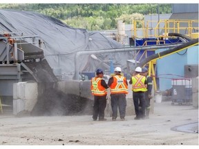 Workers carry out soil decontamination operations at a decontamination facility set up just beside the Tafisa plant on Route 161 in Lac Mégantic, Thursday, June 19, 2014. Contaminated soil is being brought from the site of the July 6, 2013, train derailment and explosion in the city’s commercial centre, which killed 47 people.