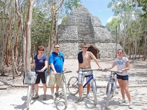 The writer’s family biking through Mexico’s Coba ruins.