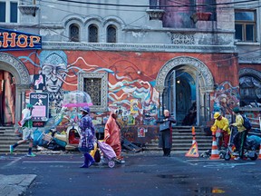 Christoph Waltz (with briefcase) in a scene from The Zero Theorem, directed by Terry Gilliam.  (Mongrel Media)