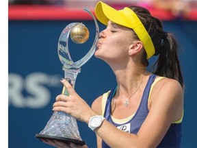Agnieszka Radwanska of Poland kisses her trophy after beating Venus Williams of the United States in the final of the 2014 Rogers Cup women’s tennis tournament at Uniprix Stadium in Montreal on Sunday, Aug. 10, 2014.
