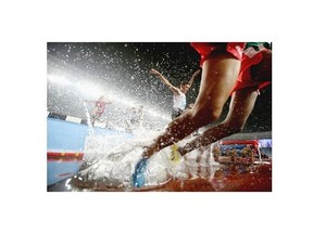 Ahmed Kenzi Saidia of Algeria (C) competes in Men’s 2000m Steeplechase Final of Nanjing 2014 Summer Youth Olympic Games at the Nanjing Olympic Sports Centre on August 25, 2014 in Nanjing, China.