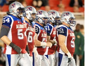 The Alouettes offensive line, from left, Jeff Perrett, Ryan Bomben, Luc Brodeur-Jourdain, Ryan White and Krisian Matte, approaches the line of scrimmage during Canadian Football League game against the Edmonton Eskimos in Montreal Friday August 08, 2014.