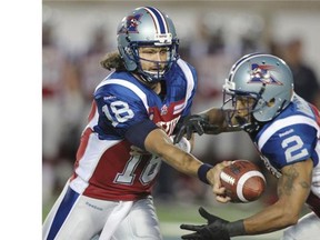 Alouettes quarterback Jonathan Crompton hands the ball off to running-back Brandon Whittaker during a Canadian Football League game against the Ottawa Redblacks in Montreal Friday.