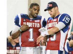 Alouettes quarterbacks Troy Smith, left, and Alex Brink on the bench during Canadian Football League game against the Edmonton Eskimos in Montreal Friday August 08, 2014.