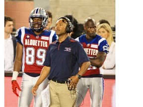 Alouettes receivers coach Erik Campbell with players Duron Carter, left, and Chad Johnson on the bench during Canadian Football League game against the Edmonton Eskimos in Montreal Friday August 08, 2014.