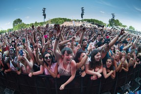 Music fans enjoy the performance by American rapper Childish Gambino on the first day of the 2014 Osheaga Music Festival at Jean-Drapeau Park in Montreal on Friday, August 1, 2014. (Dario Ayala / THE GAZETTE)