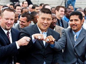 Bryan Chiu was flanked by then-teammates Scott Flory, left, and Anthony Calvillo as they showed off their show off their CFL Championship rings during a ceremony in 2010. (Dario Ayala /Gazette files)