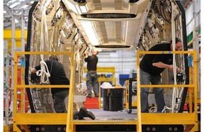 Workers assemble a train car at the Bombardier plant in Derby, England. In Ontario, managers are doing some building work.