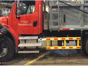 A TV cameraman photographs new rails during a news conference Wednesday, August 13, 2014, as the city of Montreal announced it has started installing protective barriers on the sides of its larger trucks in hopes of better protecting cyclists in collisions.