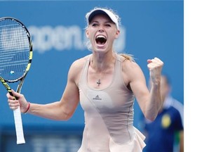 Caroline Wozniacki of Denmark reacts after defeating Maria Sharapova of Russia during the fourth round of the 2014 U.S. Open tennis tournament Sunday in New York.